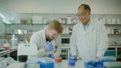 Colorifix Two men in white lab coats in a science lab.